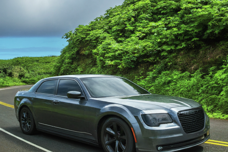 Luxury car traveling the Road to Hana